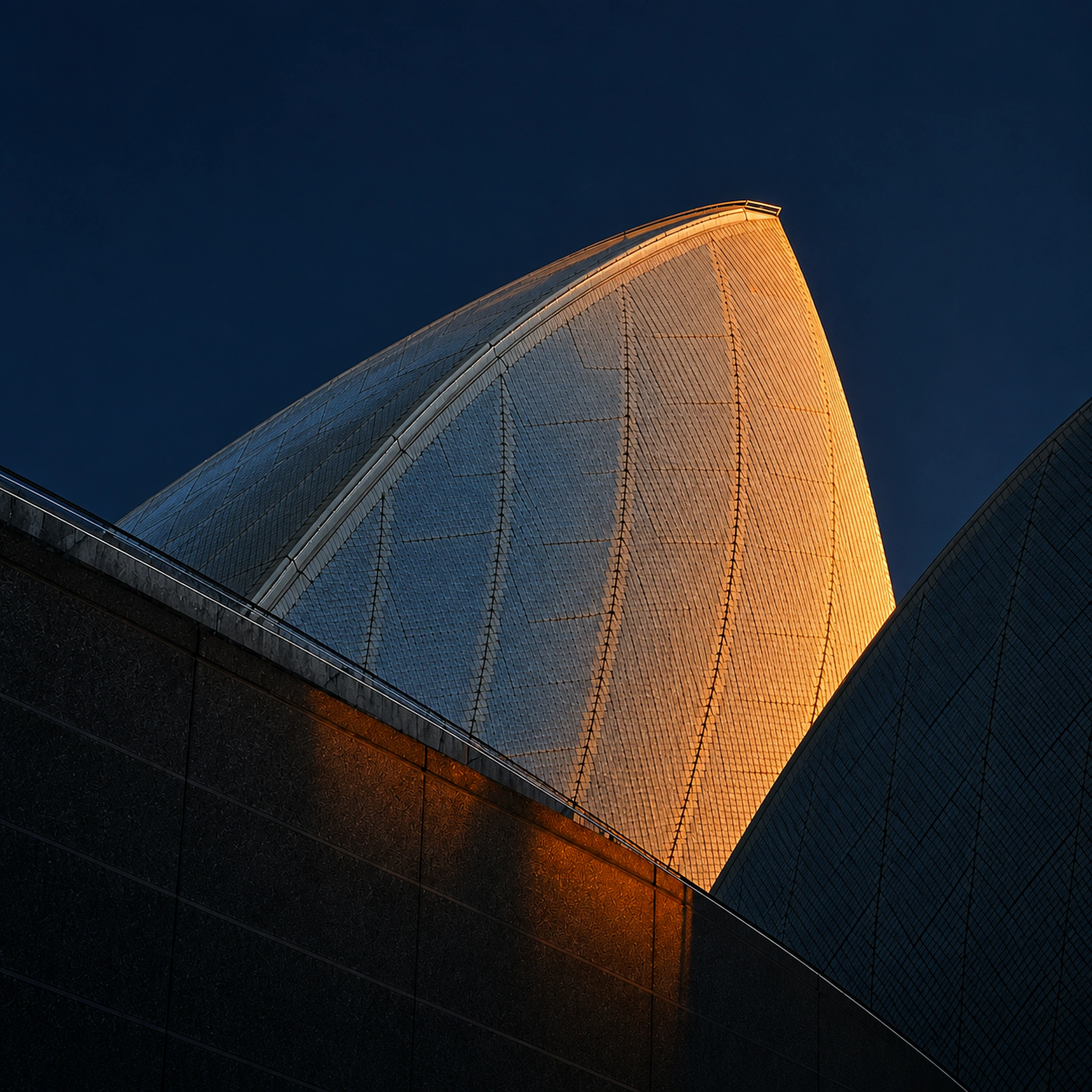 Illuminated tiled sail rising against a deep navy sky